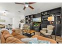 Elegant living room features a cozy fireplace, tile flooring, and a stylish ceiling fan at 612 Cedar Park Dr, Daytona Beach, FL 32114