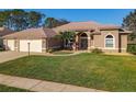 Charming single-story home with lush green lawn and arched entryway, located in a desirable neighborhood at 6456 Cypress Springs Pkwy, Port Orange, FL 32128
