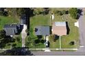 Birds eye view of home and neighboring houses showing the landscaping, roof, and driveways at 902 Conrad Dr, New Smyrna Beach, FL 32168