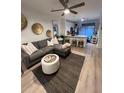 Contemporary living space featuring sleek decor, a comfortable couch, and natural light from the kitchen at 911 N Orange Ave # 528, Orlando, FL 32801