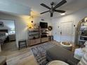 Cozy living room with modern ceiling fan and hardwood flooring, leading into the bedroom at 911 N Orange Ave # 528, Orlando, FL 32801