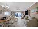 Cozy living room featuring tile floors, comfortable seating, and sliding glass doors with ocean view at 111 N Atlantic Ave # A219, New Smyrna Beach, FL 32169