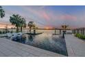 Beautiful waterfront pool featuring a fire pit, lounge chairs, and stunning sunset views at 1194 N Peninsula, New Smyrna Beach, FL 32169