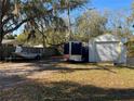 View of the property's backyard with a boat, storage trailer, and shed at 1208 Pat Ave, New Smyrna Beach, FL 32168
