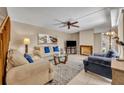 Cozy living room features comfortable seating, a fireplace, and neutral decor, creating an inviting space at 135 Cedar Dunes Dr, New Smyrna Beach, FL 32169