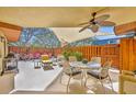 Charming covered patio with outdoor dining set and seating, ideal for enjoying meals and gatherings at 135 Cedar Dunes Dr, New Smyrna Beach, FL 32169