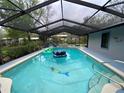 Screened-in pool with slide and lounge area offers a refreshing escape in a private backyard setting at 1370 Jane Lacey Ln, New Smyrna Beach, FL 32168