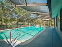 Enclosed pool with slide, waterfall feature and screened enclosure for outdoor enjoyment at 1370 Jane Lacey Ln, New Smyrna Beach, FL 32168