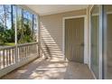 Enclosed screened porch with views of trees and exterior door leading to the outdoors at 1600 Big Tree Rd # I2, South Daytona, FL 32119