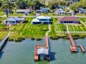 An aerial view of this waterfront home featuring lush lawns, private dock, boat lift, and water access at 2019 S Riverside, Edgewater, FL 32141