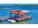 Waterfront property featuring a private dock with an upper deck and boat lift at 2019 S Riverside, Edgewater, FL 32141