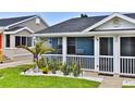 Close up on the blue exterior of a home with white picket fences and manicured lawn at 216 Kirkland Dr, New Smyrna Beach, FL 32169