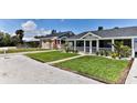 Street view of houses with well-manicured lawns and white picket fences at 216 Kirkland Dr, New Smyrna Beach, FL 32169