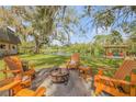 Backyard features a fire pit and view of the serene lake, with a covered dock at 2533 Glenhaven St, New Smyrna Beach, FL 32168