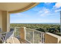 Breathtaking balcony view overlooking lush greenery and the ocean, creating a serene and relaxing atmosphere at 261 Minorca Beach Way # 606, New Smyrna Beach, FL 32169