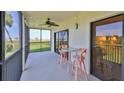 Relax on this screened balcony with a ceiling fan, comfortable seating, and panoramic views of the marina at 2700 N Peninsula Ave # 113, New Smyrna Beach, FL 32169