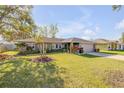 Beautiful home with lush green lawn and mature landscaping at 2828 Pine Tree Dr, Edgewater, FL 32141