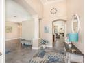 Grand foyer featuring tile floors, columns, and an archway leading to the living spaces at 2908 Cypress Ridge Trl, Port Orange, FL 32128