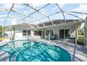 Outdoor living area featuring a screened-in pool with a spacious patio perfect for relaxing or entertaining at 2908 Cypress Ridge Trl, Port Orange, FL 32128