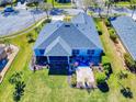 Aerial view showcasing backyard with screened lanai and patio with beautiful landscaping and lush lawn at 3611 Marisol Ct, New Smyrna Beach, FL 32168