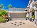 Attached two-car garage with a beautiful driveway and well-kept landscaping at 3611 Marisol Ct, New Smyrna Beach, FL 32168