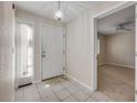 Welcoming entryway with tile floors, a bright front door, and a glimpse into the carpeted living space at 407 Bouchelle Dr # 205, New Smyrna Beach, FL 32169