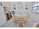 Bright dining area featuring a round table with seating for four and chandelier lighting at 4225 S Atlantic Ave # 2070, New Smyrna Beach, FL 32169