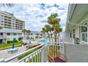 Cozy condo balcony with a view of the lush resort and inviting swimming pool at 4225 S Atlantic Ave # 2150, New Smyrna Beach, FL 32169