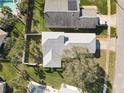 Aerial view showcases the home's layout and large lot with mature trees and privacy fencing at 4583 Barnacle Dr, Port Orange, FL 32127