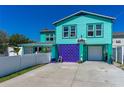 Beautiful two-story home with beach charm, garage, and colorful lattice at 519 Mobile Ave, Daytona Beach, FL 32118