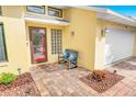 Inviting front porch with bench and colorful brick pavers to the garage and front door at 72 Oceanview Ave, Ponce Inlet, FL 32127