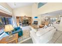 Bright living room with high ceilings, tile floors, fireplace, and view to dining and kitchen at 72 Oceanview Ave, Ponce Inlet, FL 32127