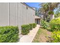 Charming townhome with meticulously maintained landscaping and a welcoming walkway at 210 Pine Cone Trl, Ormond Beach, FL 32174