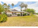Lovely home with a lush front yard, mature landscaping, and a welcoming entrance at 222 Brittany Ave, Port Orange, FL 32127