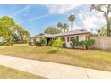 View of the home with mature landscaping, shrubs, and a well-kept lawn at 222 Brittany Ave, Port Orange, FL 32127