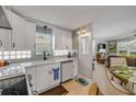 Lovely kitchen features white cabinets, stylish backsplash, and modern fixtures at 312 Jefferson Ave, Port Orange, FL 32127