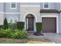 Charming front entrance with stone accents and well-maintained landscaping at 465 White Cotton Cir, Oviedo, FL 32765