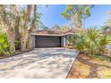 Exterior view of home showcasing a lush yard and private setting at 6205 Klondike Dr, Port Orange, FL 32127