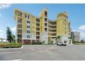 Beautiful exterior featuring yellow and white facade with multiple stories and ample parking space at 7 Riverwalk Dr # 206, New Smyrna Beach, FL 32169