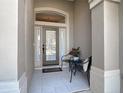 Inviting front porch with tile flooring and seating area at 1077 Crystal Creek Dr, Port Orange, FL 32128