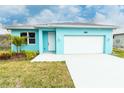 Charming home featuring a light blue exterior, a white garage door, and an inviting front entrance at 113 Douglas St, Edgewater, FL 32141