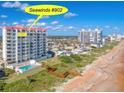 Seawinds #902 exterior view showcasing oceanfront access, a pool and coastal charm at 1183 Ocean Shore Blvd # 902, Ormond Beach, FL 32176