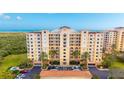 Beautiful condominium with private balconies, lush landscaping, and ample parking for residents and guests at 261 Minorca Beach Way # 406, New Smyrna Beach, FL 32169