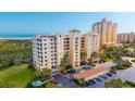 Coastal condominium showcasing architecture, nearby beach, and private balconies with serene neighborhood view at 261 Minorca Beach Way # 406, New Smyrna Beach, FL 32169