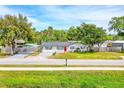 Charming single-story home featuring a well-manicured front yard and a welcoming red front door at 2809 Lime Tree Dr, Edgewater, FL 32141