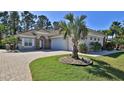 Beautiful one-story home with a tile roof, paved driveway, and mature landscaping at 2904 Palma Ln, New Smyrna Beach, FL 32168