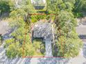 An aerial view of a single story home with mature trees and a defined property line at 2921 India Palm Dr, Edgewater, FL 32141