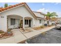 Condo exterior with stucco facade, terracotta roof, and landscaped front yard with seating area at 3522 Forest Branch Dr # B, Port Orange, FL 32129