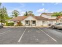 Exterior shot of the condo, with vibrant foliage, parking, and tile roofing at 3522 Forest Branch Dr # B, Port Orange, FL 32129