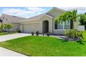 Charming single-story home featuring a two car garage, well-maintained lawn, and inviting front entrance at 532 White Coral Ln, New Smyrna Beach, FL 32168